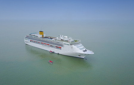 White luxury cruise ship docked in beautiful Caribbean sea close to the beachの写真素材
