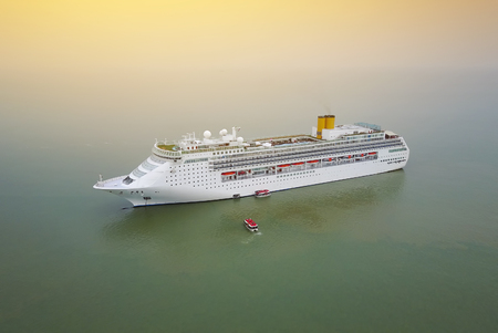 Aerial view of White luxury cruise ship docked in beautiful Caribbean sea close to the beach.の写真素材