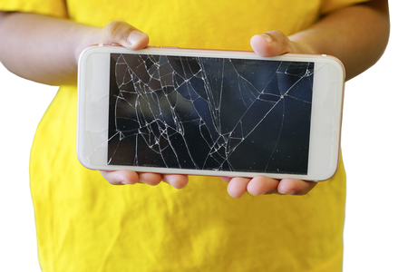 Kids holding a crack smartphone isolated on white backgroundの写真素材