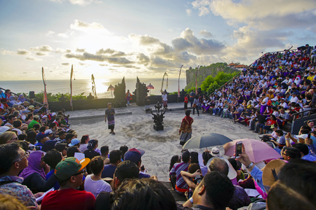 Bali, Indonesia - April 19: Tourists watch traditional Balinese Kecak Dance at Uluwatu Temple on Bali, Indonesia. Kecak (also known as Ramayana Monkey Chant) is very popular cultural show on Bali.のeditorial素材