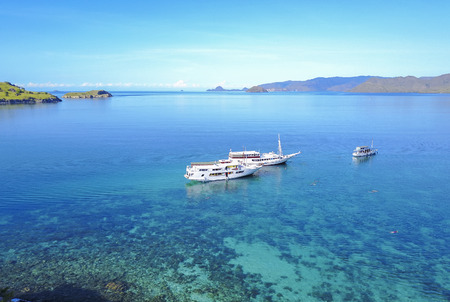 Tourist boats at Gili lawa island with a clear blue sea, Flores, Indonesia .の写真素材