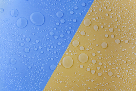 Water Drops on blue and yellow backgroundの写真素材
