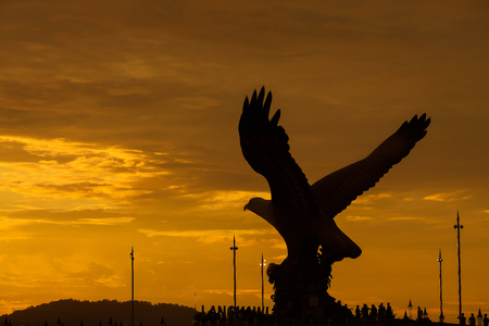Silhouette of majestic Eagle Statue in Langkawi during beuatiful golden sunsetの写真素材