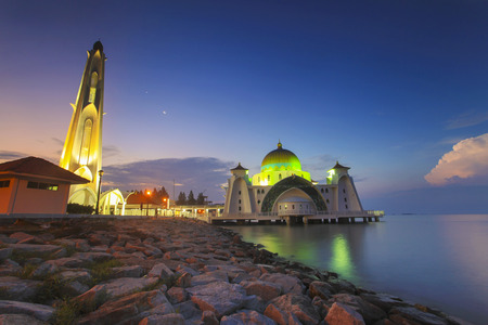 Blue hour at beautiful Malacca Straits Mosque with moon at backgroundの写真素材