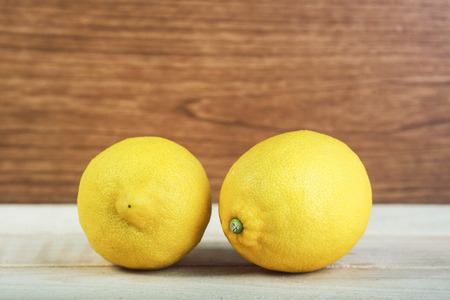 Fresh lemon fruit on wooden and blue backgroundの写真素材