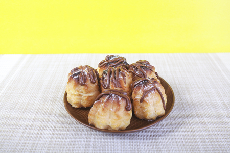 Chocolate cream puff on wooden backgroundの写真素材