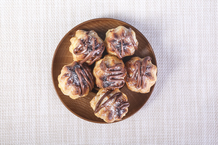 Chocolate cream puff on wooden backgroundの写真素材