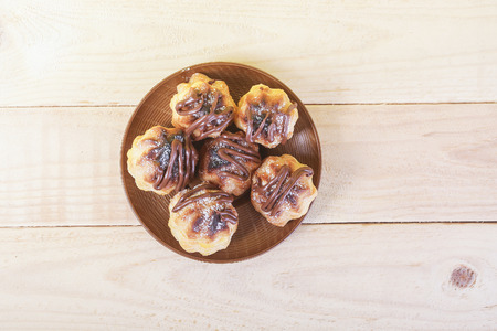 Chocolate cream puff on wooden background.の写真素材