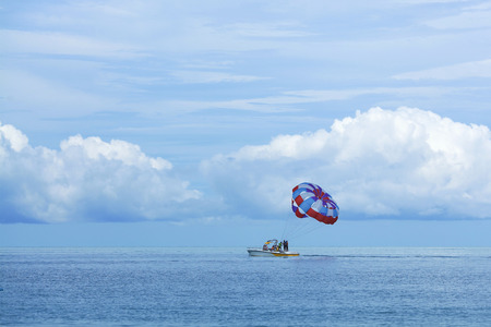 Parasailing is a popular pastime in many resorts around the world. The active form of relaxation. Focus on a parachuteの写真素材