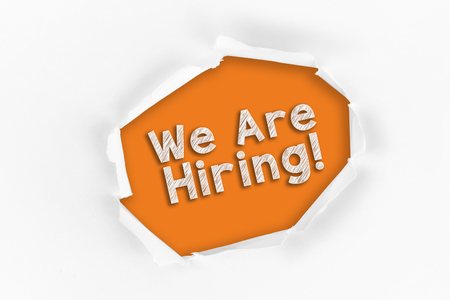 Torn paper with a We Are Hiring word on redの写真素材