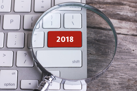 Business concept: 2018 on computer keyboard on wooden with copyspace areaの写真素材