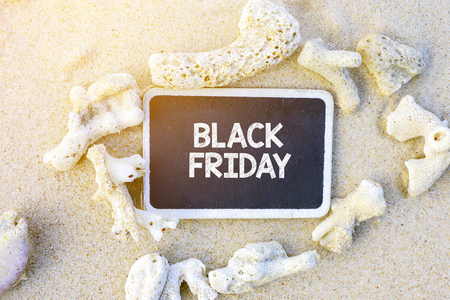 BLACK FRIDAY text written on chalkboard, on beachの写真素材