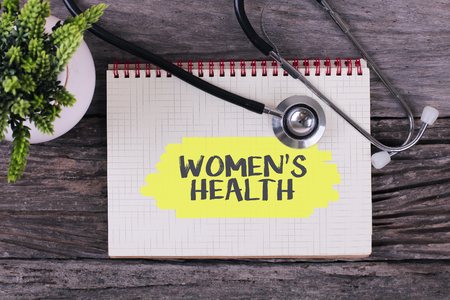 Women's Health word on notebook,stethoscope and green plantの写真素材