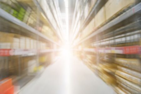 Warehouse industrial and logistics companies. The boxes on high shelves stocked. Motion blur effect. Bright sunlight.の写真素材