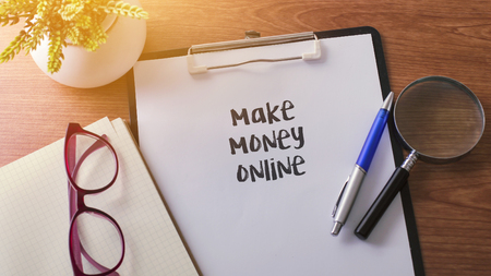 Make Money Online word on paper with glass ballpen and green plantの写真素材