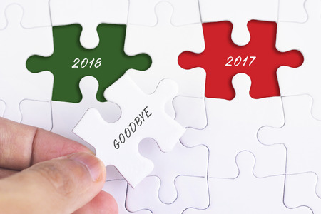 Business Concept - Female hand and missing puzzle with GOODBYE 2O17 wordの写真素材