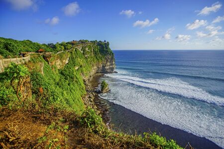 The hindu temple Pura Luhur Uluwatu situated over the cliffs of South Kuta, Bali, Indonesiaの写真素材