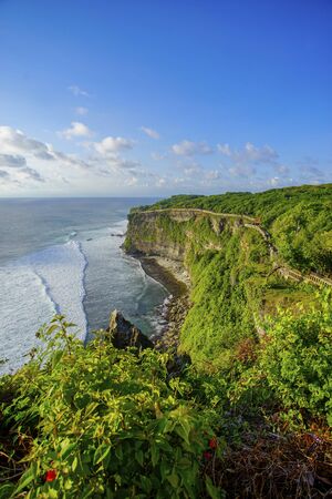 The hindu temple Pura Luhur Uluwatu situated over the cliffs of South Kuta, Bali, Indonesiaの写真素材