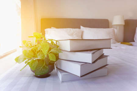 Stack of books on the white bed. Education background with Copy space.の写真素材