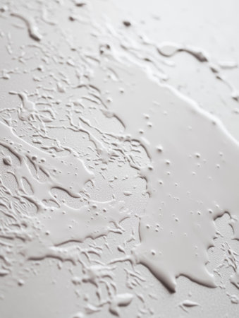 Close-up of water droplets scattered on a white surface. - aiの素材