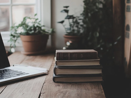 Stack of books with laptop on wooden table  - aiの素材