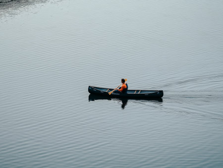 Man rowing his canoe on a lake, - aiの素材
