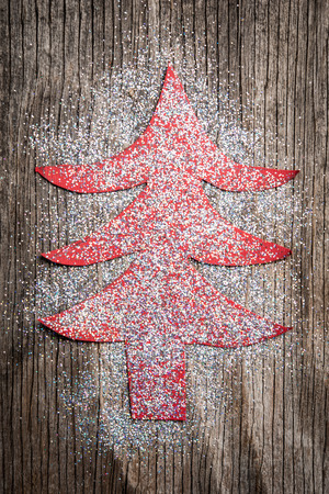 Paper Christmas tree over rustic wooden background as New Year cardの写真素材