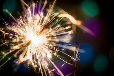 Christmas sparklers and background with colorful bokehの写真素材