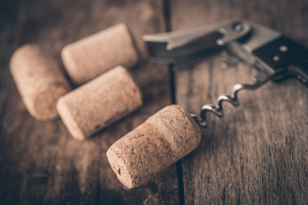 Wine cork and corkscrew on wooden tableの写真素材