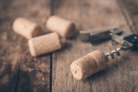 Wine cork and corkscrew on wooden tableの写真素材