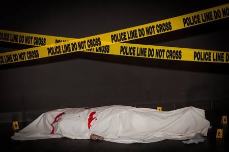 Street crime scene with police line do not cross yellow warning tapeの写真素材