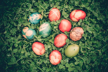 Colorful decorated eggs for Easter in grass top viewの写真素材