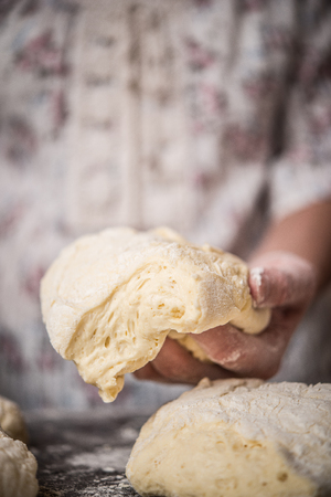 Housewife making dough for dumplings or pastaの写真素材