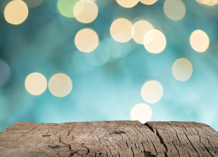 Wooden table in front of bokeh background, for display and montage product for holidayの写真素材