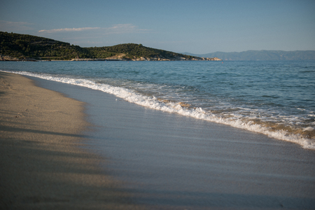 Sea wave with sand beach as backgroundの写真素材