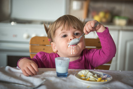 The girl is eating aloneの写真素材
