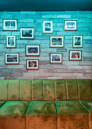 Decorated brick wall and sofa in caffee bar interiorの写真素材