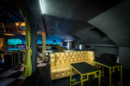 Big golden sofa in interior of contemporary discothequeの写真素材