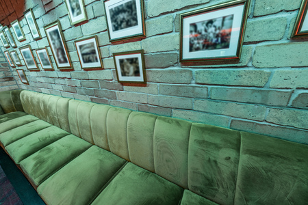 Lounge bar interior with brick wall and big sofaの写真素材