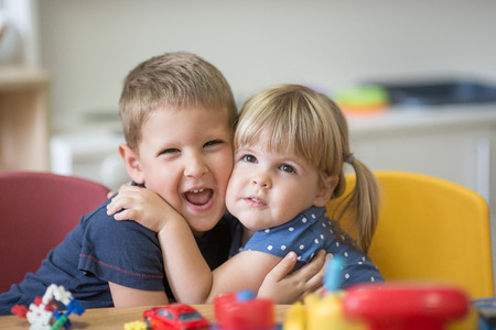 Blonde brother and sister is huggingの写真素材