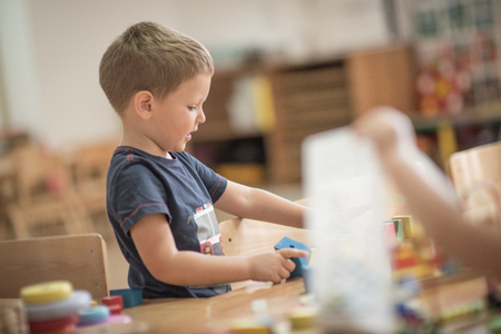 Little caucasian boy is playing at kindergartenの写真素材