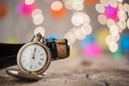 Background for New Year congratulations with clock and champagne corkの写真素材