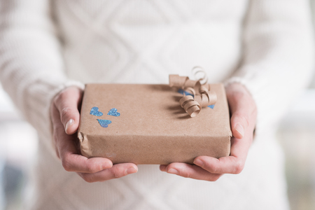 Present box with in womans handsの写真素材