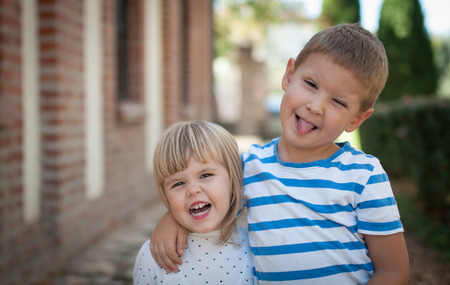 Outdoor portrait od caucasian children making grimaceの写真素材