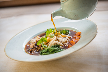 Vegan ramen with udon noodles serving in restaurantの写真素材
