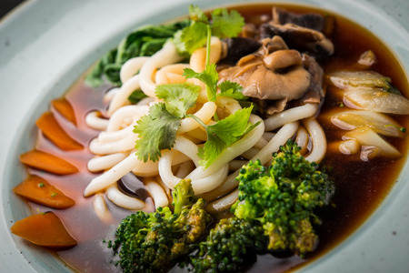 Ramen with udon noodle, bok choy, shiitake, close up vegan dishの写真素材
