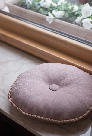 Little gray pillow for sitting next to windowの写真素材
