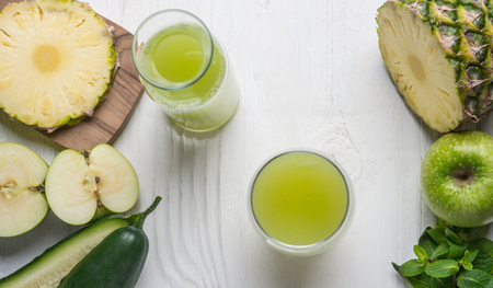 Top viev of glass juice made of cucumber, apple and pineappleの写真素材