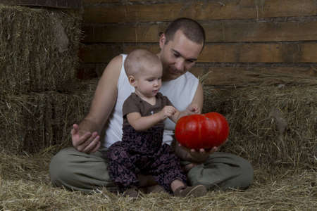 man and child look on the pumpkinの写真素材