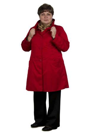 Middle-aged woman in a red cape on a white backgroundの写真素材